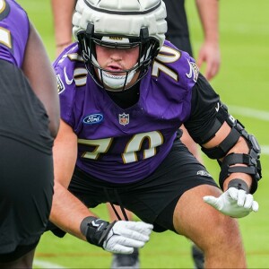 Handing out gold, silver and bronze medals at Ravens training camp