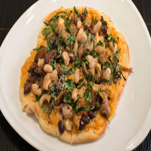 Grilled Flatbread with Spicy White Bean Purée, Mushrooms, Kale, and Sausage