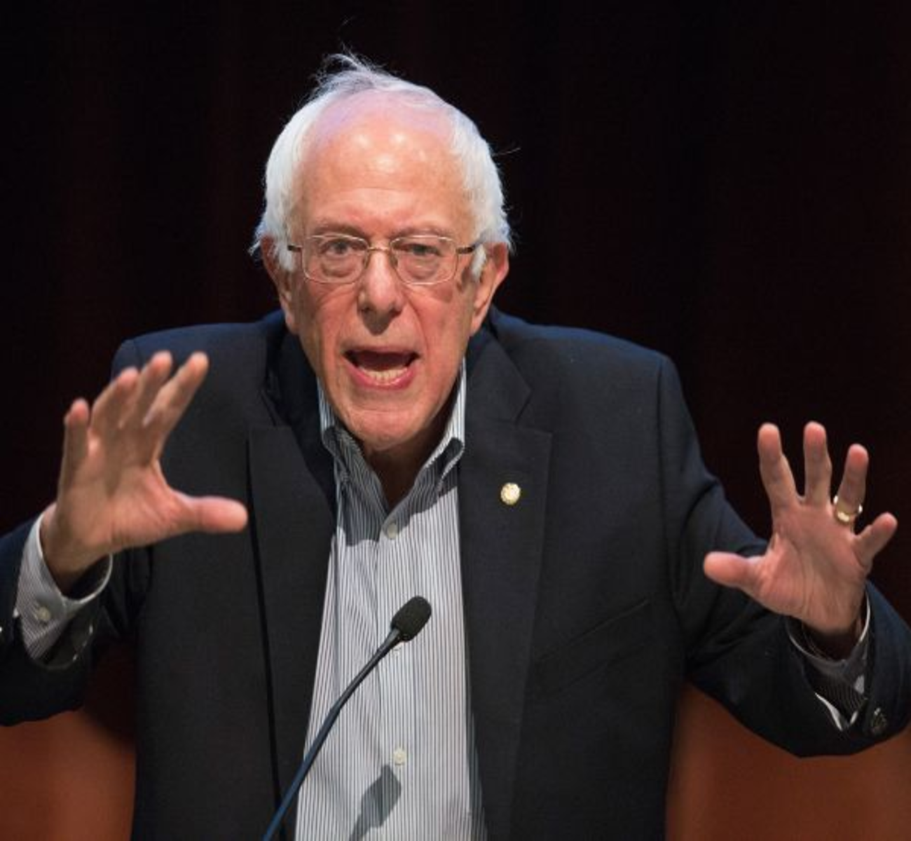 Bernie Sanders stops by, followed by an unknown woman from a neighbourhood welcome committee